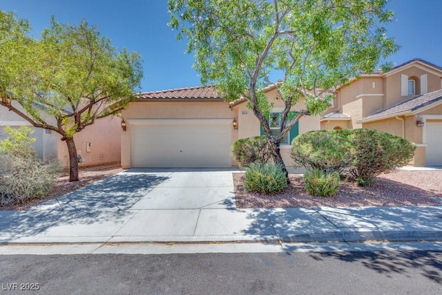 5013 Diamond Ranch Ave, Las Vegas, NV 89131 - mediterranean / spanish-style home with a tile roof, stucco siding, an attached garage, and driveway