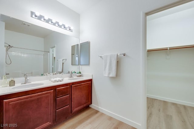 5013 Diamond Ranch Ave, Las Vegas, NV 89131 - bathroom featuring wood finished floors, double vanity, and a spacious closet