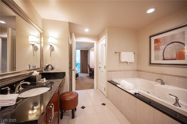 135 E Harmon Ave Unit 414, Las Vegas, NV 89109 - ensuite bathroom featuring a whirlpool tub, vanity, recessed lighting, and tile patterned floors