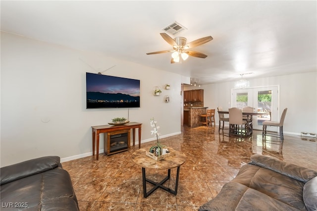 170 Palisade Ave, Las Vegas, NV 89110 - living room featuring a ceiling fan, a chandelier, and tile patterned floors