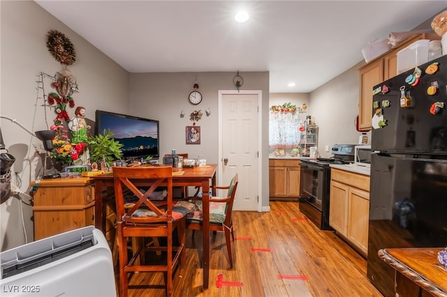 170 Palisade Ave, Las Vegas, NV 89110 - kitchen featuring black appliances, light wood-type flooring, light countertops, recessed lighting, and light brown cabinetry