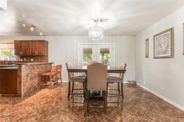 170 Palisade Ave, Las Vegas, NV 89110 - dining area featuring a chandelier, french doors, and dark tile patterned flooring