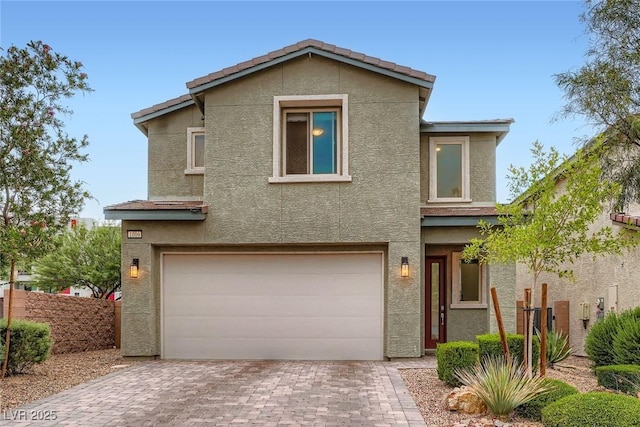 1009 Bluebell Brook St, Henderson, NV 89052 - view of front of house with stucco siding, a garage, and decorative driveway
