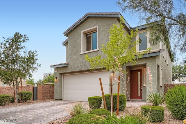 1009 Bluebell Brook St, Henderson, NV 89052 - view of front of property with a garage, stucco siding, and driveway