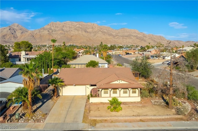 744 Milstead Ct, Las Vegas, NV 89110 - view of front of home featuring a residential view, an attached garage, a mountain view, and concrete driveway
