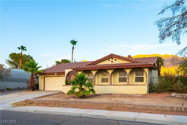 744 Milstead Ct, Las Vegas, NV 89110 - view of front facade with driveway, a garage, a tiled roof, and stucco siding