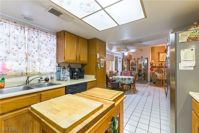 744 Milstead Ct, Las Vegas, NV 89110 - kitchen featuring freestanding refrigerator, butcher block countertops, dishwasher, light tile patterned flooring, and brown cabinetry