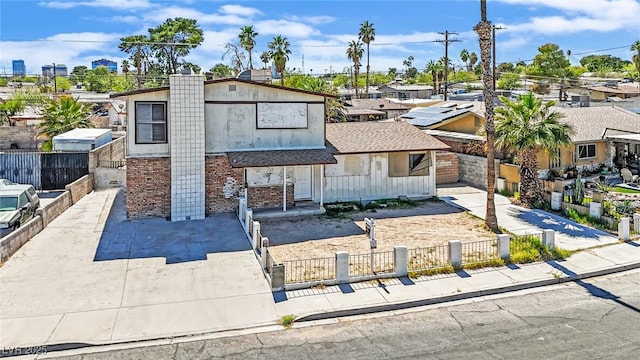 3009 Merritt Ave, Las Vegas, NV 89102 - view of front of house featuring brick siding and a fenced front yard