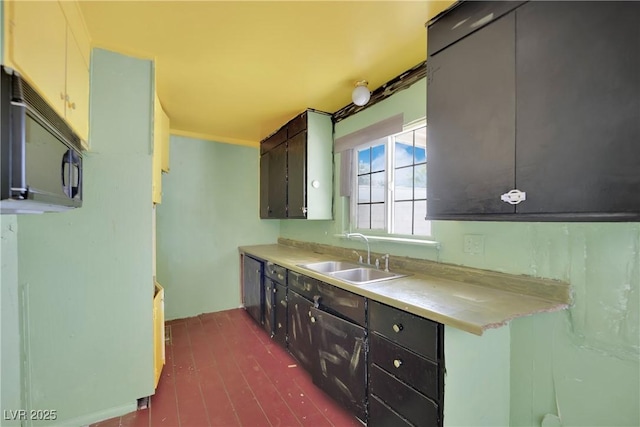 3009 Merritt Ave, Las Vegas, NV 89102 - kitchen with black microwave, light countertops, and dark wood finished floors