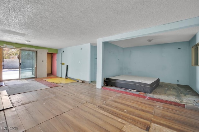 3009 Merritt Ave, Las Vegas, NV 89102 - unfurnished living room featuring a textured ceiling and light wood-style floors
