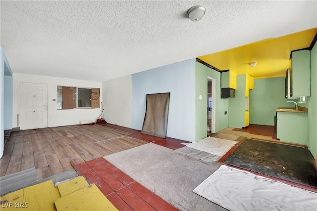 3009 Merritt Ave, Las Vegas, NV 89102 - unfurnished living room with a textured ceiling and wood finished floors