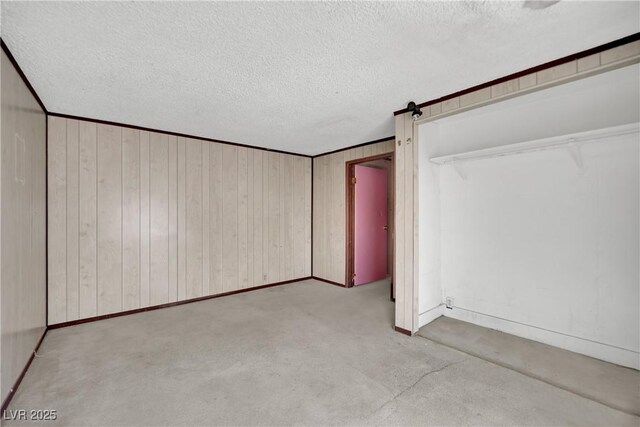 3009 Merritt Ave, Las Vegas, NV 89102 - unfurnished bedroom featuring carpet flooring, a textured ceiling, and wooden walls