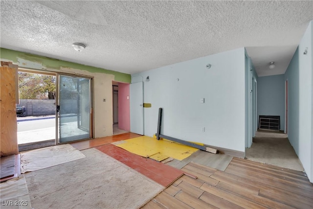3009 Merritt Ave, Las Vegas, NV 89102 - unfurnished living room with wood finished floors and a textured ceiling
