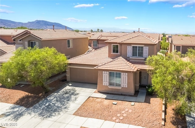 1014 Lone Pine River Ave, Henderson, NV 89002 - view of front of property featuring stucco siding, a tile roof, a mountain view, driveway, and a garage