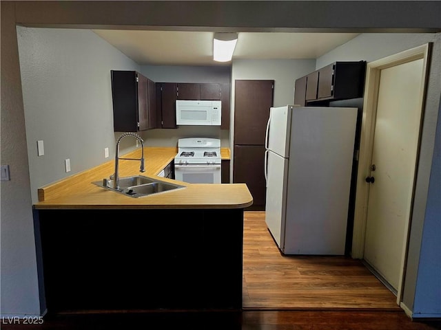 123 Sirnoble St, Las Vegas, NV 89110 - kitchen featuring white appliances, a peninsula, light countertops, and light wood-style floors