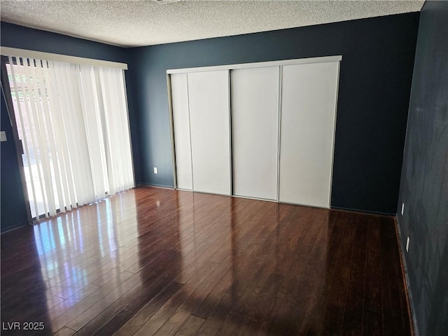 123 Sirnoble St, Las Vegas, NV 89110 - unfurnished bedroom with wood finished floors, a closet, and a textured ceiling