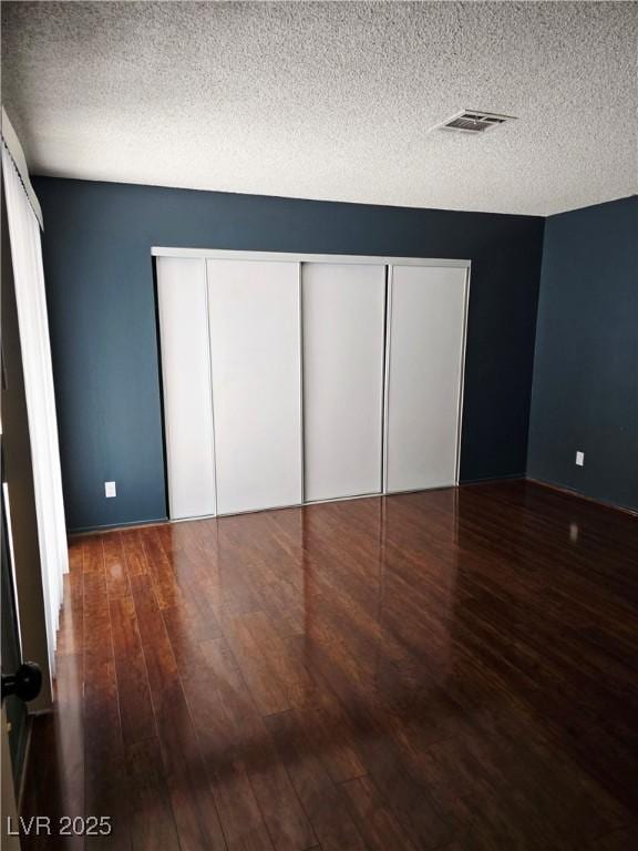 123 Sirnoble St, Las Vegas, NV 89110 - unfurnished bedroom featuring wood finished floors and a textured ceiling