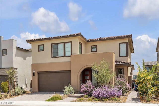1309 Azure Jay Ave, North Las Vegas, NV 89084 - view of front facade with stucco siding, an attached garage, driveway, and a tiled roof