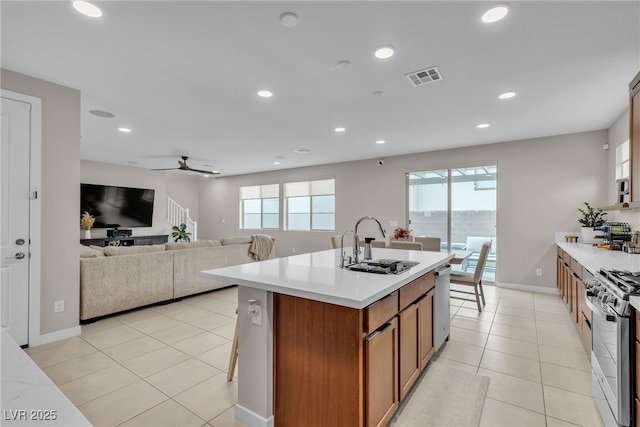 1309 Azure Jay Ave, North Las Vegas, NV 89084 - kitchen with stainless steel appliances, light countertops, recessed lighting, brown cabinets, and a ceiling fan