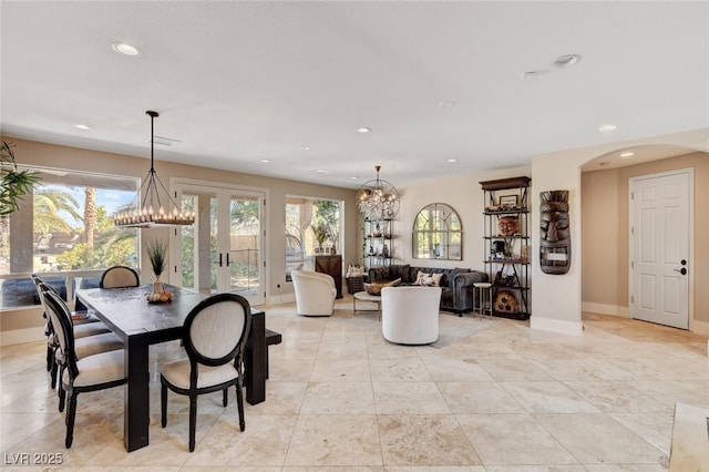 10960 Bethel Park Ct, Las Vegas, NV 89141 - dining space featuring recessed lighting, a chandelier, arched walkways, french doors, and light tile patterned flooring