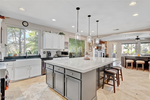10960 Bethel Park Ct, Las Vegas, NV 89141 - kitchen with appliances with stainless steel finishes, recessed lighting, a center island, light stone counters, and a kitchen breakfast bar