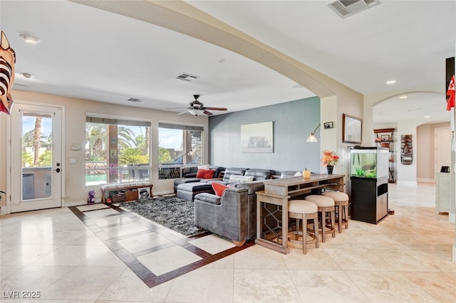 10960 Bethel Park Ct, Las Vegas, NV 89141 - living area featuring arched walkways, plenty of natural light, a ceiling fan, light tile patterned floors, and recessed lighting