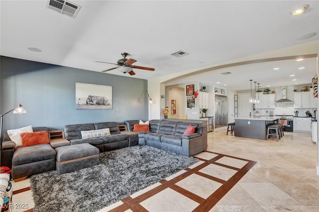 10960 Bethel Park Ct, Las Vegas, NV 89141 - living room featuring a ceiling fan, recessed lighting, and arched walkways