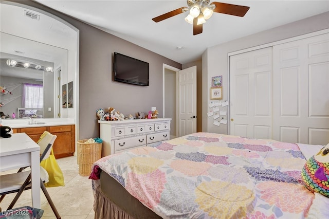 10960 Bethel Park Ct, Las Vegas, NV 89141 - bedroom featuring a closet, light tile patterned flooring, ceiling fan, and ensuite bathroom