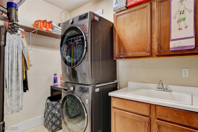10960 Bethel Park Ct, Las Vegas, NV 89141 - washroom featuring stacked washer / drying machine and cabinet space