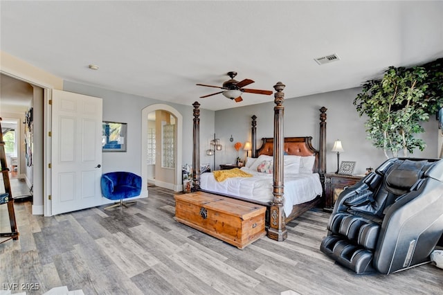 10960 Bethel Park Ct, Las Vegas, NV 89141 - bedroom featuring light wood-style flooring, arched walkways, and a ceiling fan