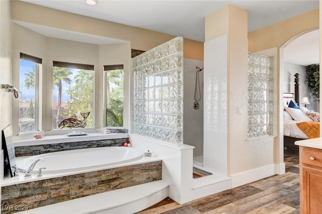 10960 Bethel Park Ct, Las Vegas, NV 89141 - bathroom with a shower stall, a bath, wood finished floors, and connected bathroom