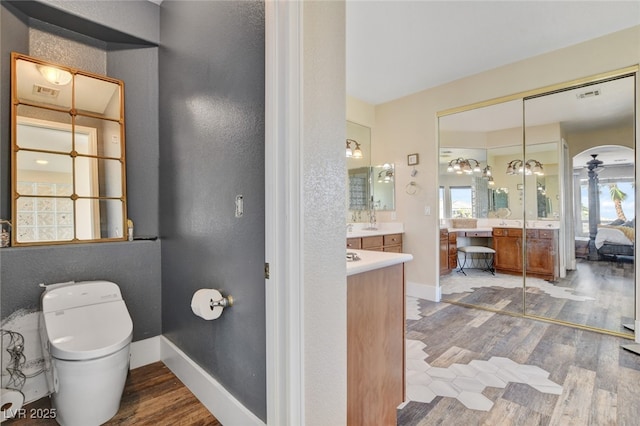 10960 Bethel Park Ct, Las Vegas, NV 89141 - ensuite bathroom with wood finished floors, vanity, and a textured wall