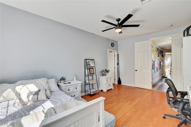 10960 Bethel Park Ct, Las Vegas, NV 89141 - bedroom with light wood-type flooring, ceiling fan, and an office area