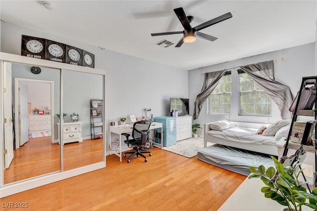 10960 Bethel Park Ct, Las Vegas, NV 89141 - bedroom featuring light wood-type flooring, an office area, and a ceiling fan
