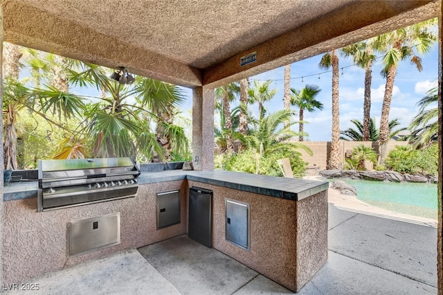 10960 Bethel Park Ct, Las Vegas, NV 89141 - fenced backyard with exterior kitchen and a patio area