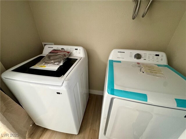 8600 W Charleston Blvd Unit 2161, Las Vegas, NV 89117 - laundry area with wood finished floors and washing machine and dryer
