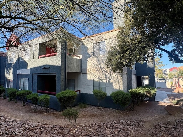 8600 W Charleston Blvd Unit 2161, Las Vegas, NV 89117 - view of side of home with stucco siding and a chimney