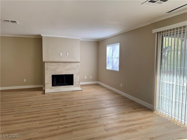 8600 W Charleston Blvd Unit 2161, Las Vegas, NV 89117 - unfurnished living room featuring ornamental molding, light wood-style floors, and a tiled fireplace