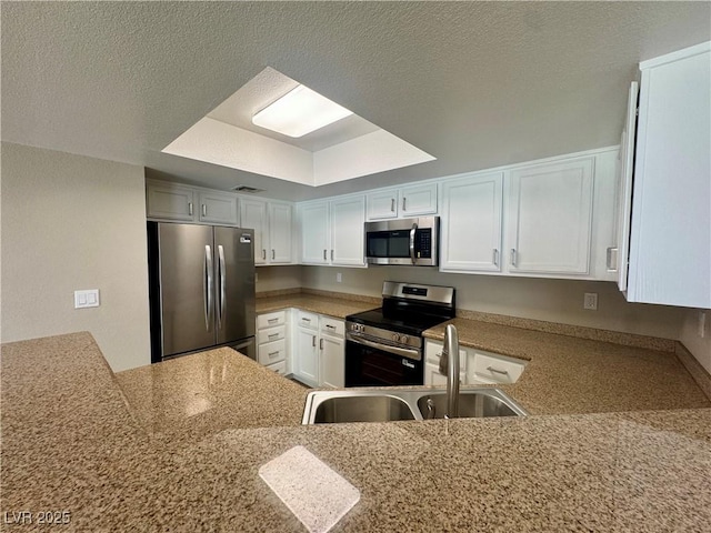 8600 W Charleston Blvd Unit 2161, Las Vegas, NV 89117 - kitchen featuring appliances with stainless steel finishes, white cabinetry, and a textured ceiling
