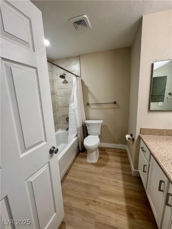 8600 W Charleston Blvd Unit 2161, Las Vegas, NV 89117 - bathroom with vanity, wood finished floors, shower / bath combination with curtain, and a textured ceiling
