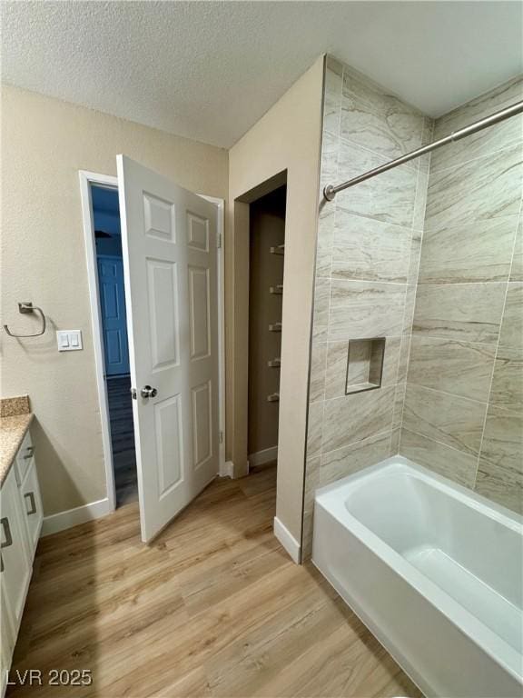 8600 W Charleston Blvd Unit 2161, Las Vegas, NV 89117 - bathroom with vanity, wood finished floors, shower / bath combination, and a textured ceiling