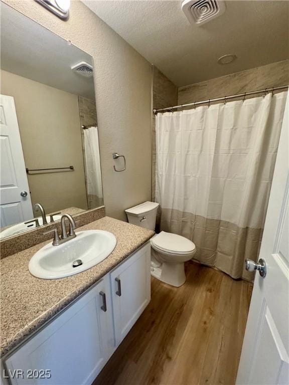 8600 W Charleston Blvd Unit 2161, Las Vegas, NV 89117 - bathroom with wood finished floors, vanity, and a textured ceiling