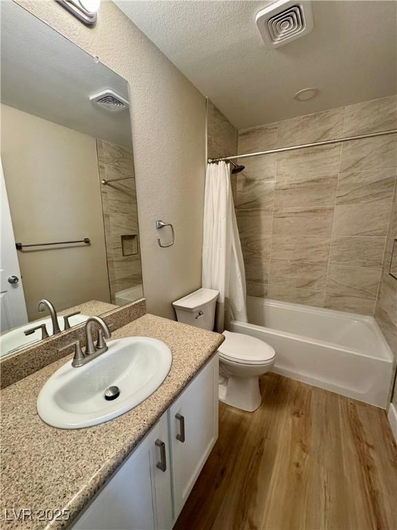 8600 W Charleston Blvd Unit 2161, Las Vegas, NV 89117 - bathroom featuring vanity, shower / bath combo, wood finished floors, and a textured ceiling