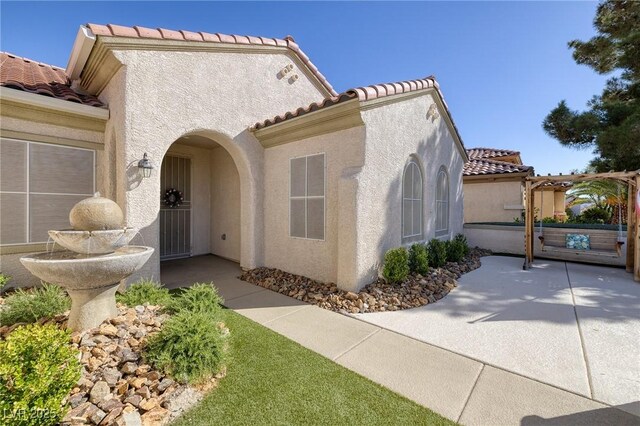 2559 Deora Way, Henderson, NV 89052 - view of front of property featuring a tiled roof, stucco siding, and a patio area