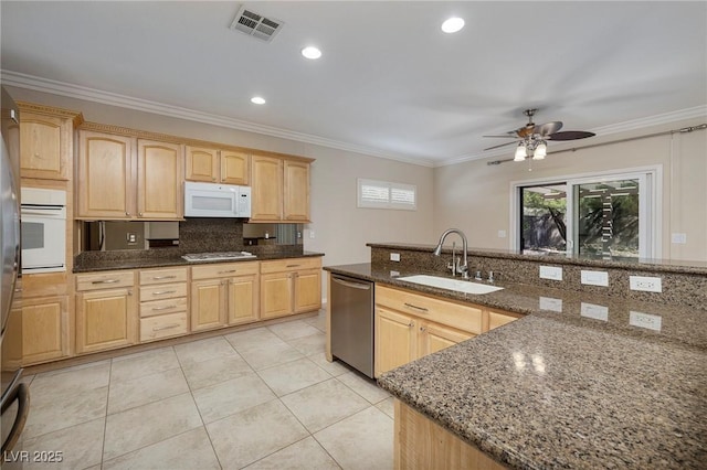 2559 Deora Way, Henderson, NV 89052 - kitchen featuring appliances with stainless steel finishes, light brown cabinetry, decorative backsplash, dark stone counters, and ornamental molding