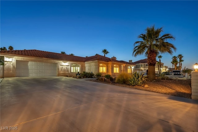 1971 Del Font Ct, Las Vegas, NV 89117 - mediterranean / spanish house featuring concrete driveway, a garage, and stucco siding