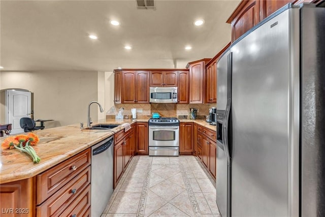 1971 Del Font Ct, Las Vegas, NV 89117 - kitchen featuring stainless steel appliances, inlaid floor details, a peninsula, recessed lighting, and backsplash