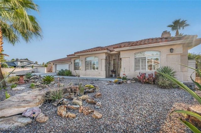 1971 Del Font Ct, Las Vegas, NV 89117 - mediterranean / spanish-style house with a garage, a tile roof, a chimney, and stucco siding