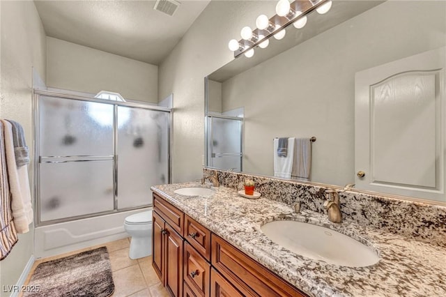 1971 Del Font Ct, Las Vegas, NV 89117 - full bath featuring double vanity, tile patterned flooring, and bath / shower combo with glass door