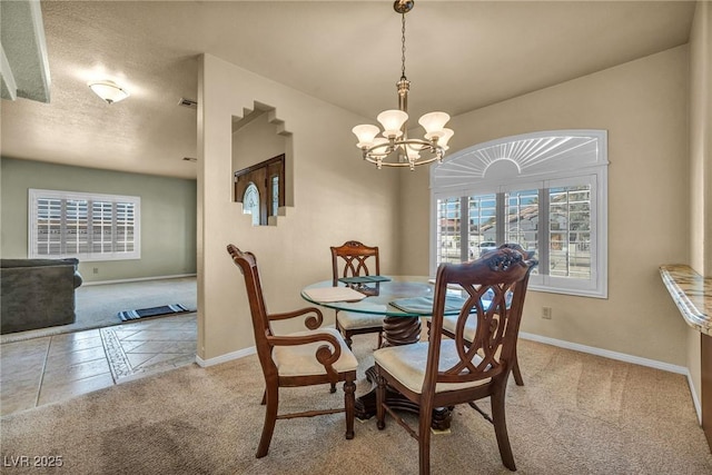 1971 Del Font Ct, Las Vegas, NV 89117 - carpeted dining room with a chandelier and baseboards